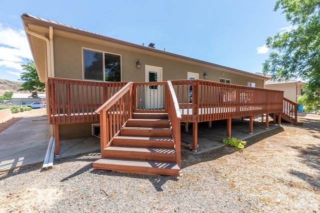 back of property featuring a wooden deck