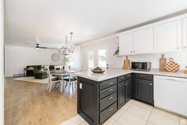 12138 S Willmar Cir, Riverton, UT 84065 - kitchen with dishwasher, stainless steel microwave, white cabinets, light countertops, and a peninsula