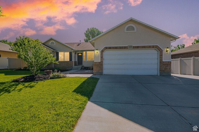 12138 S Willmar Cir, Riverton, UT 84065 - ranch-style home featuring driveway, an attached garage, stucco siding, and brick siding