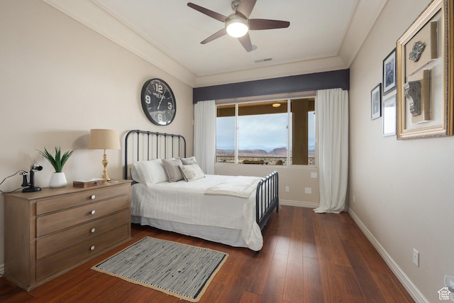 bedroom featuring crown molding, ceiling fan, and dark hardwood / wood-style floors