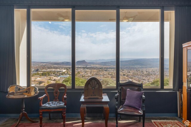 sitting room with a mountain view and a healthy amount of sunlight