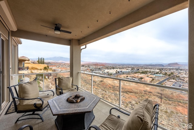 balcony featuring a mountain view and an outdoor fire pit