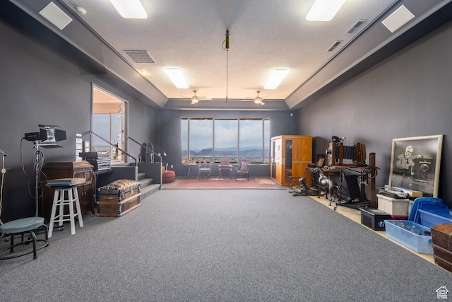 misc room featuring ceiling fan and carpet flooring