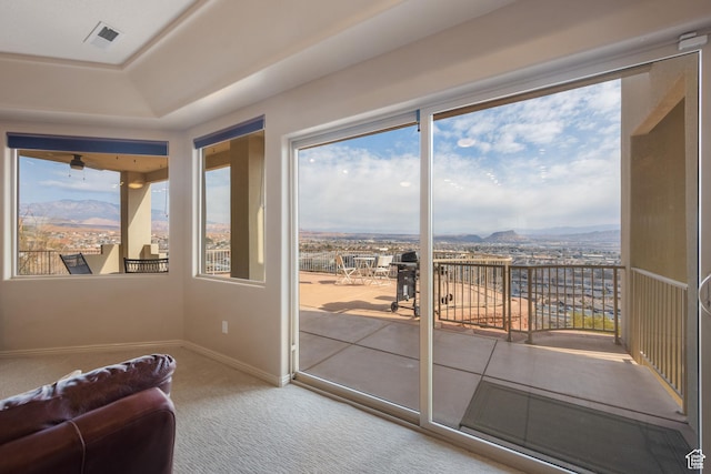 doorway featuring a mountain view and carpet floors