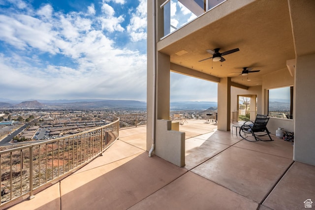 view of patio featuring a mountain view and ceiling fan