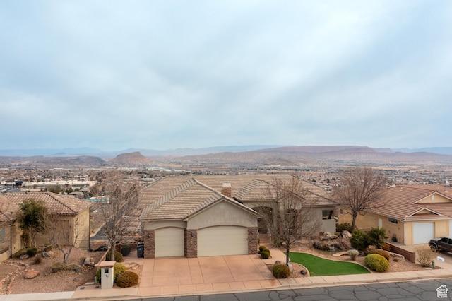 single story home featuring a garage and a mountain view