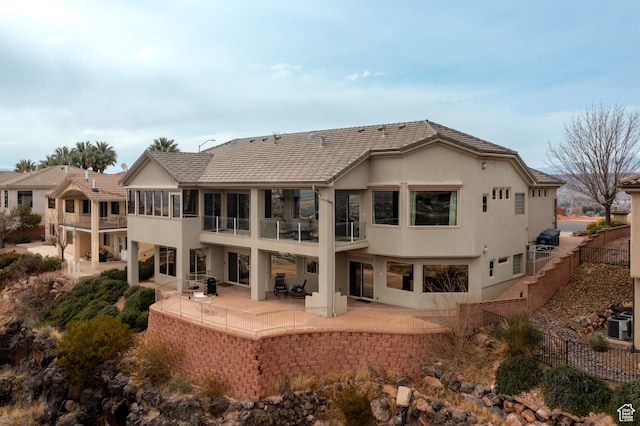 rear view of house with a patio and central air condition unit