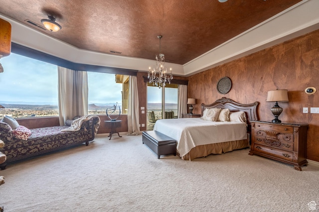 carpeted bedroom featuring an inviting chandelier, a tray ceiling, access to outside, and a textured ceiling