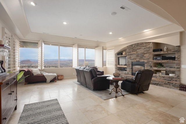 living room featuring light tile patterned flooring and a fireplace