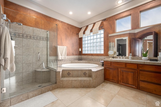 bathroom featuring independent shower and bath, vanity, ornamental molding, and tile patterned flooring
