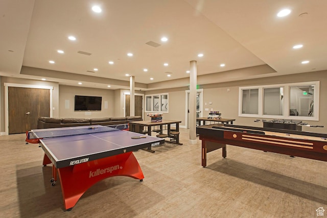 recreation room featuring a tray ceiling