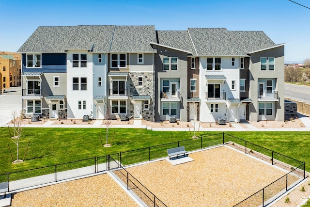 exterior space with a yard and central air condition unit