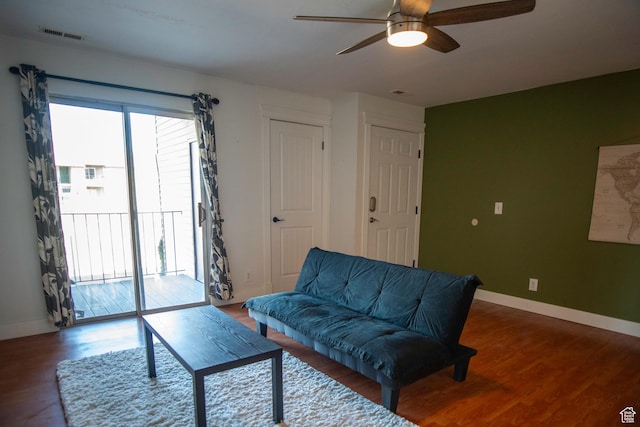 living room with hardwood / wood-style floors and ceiling fan