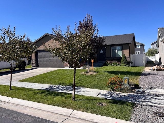view of front of house featuring a garage and a front lawn