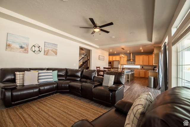 324 S Hayes Well Ln, Saratoga Springs, UT 84045 - living area with stairway, dark wood-style flooring, a textured ceiling, a raised ceiling, and a ceiling fan