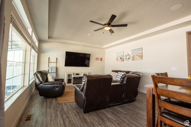 324 S Hayes Well Ln, Saratoga Springs, UT 84045 - living area featuring a raised ceiling, a textured ceiling, dark wood finished floors, visible vents, and ceiling fan