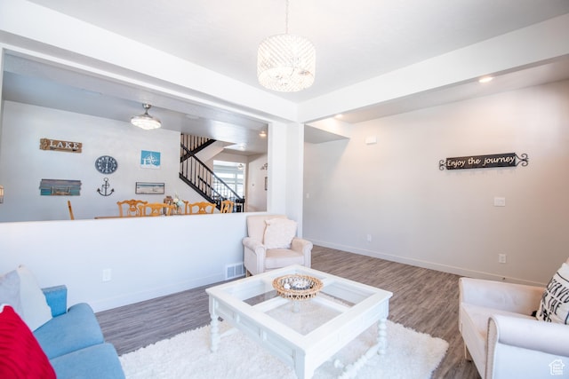 324 S Hayes Well Ln, Saratoga Springs, UT 84045 - living area featuring stairs, wood finished floors, and baseboards