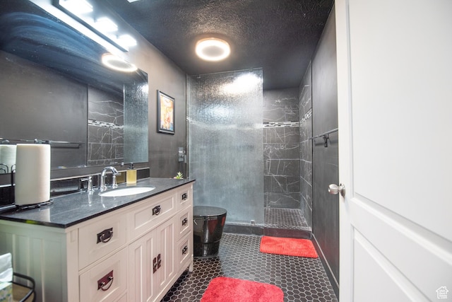 324 S Hayes Well Ln, Saratoga Springs, UT 84045 - bathroom with a tile shower, vanity, and a textured ceiling