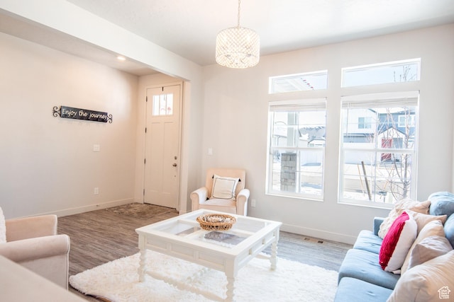 324 S Hayes Well Ln, Saratoga Springs, UT 84045 - living room with baseboards, wood finished floors, and a chandelier