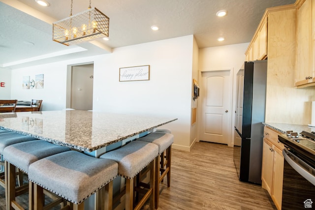 324 S Hayes Well Ln, Saratoga Springs, UT 84045 - kitchen featuring light brown cabinets, freestanding refrigerator, a kitchen bar, range with electric cooktop, and light wood-style floors