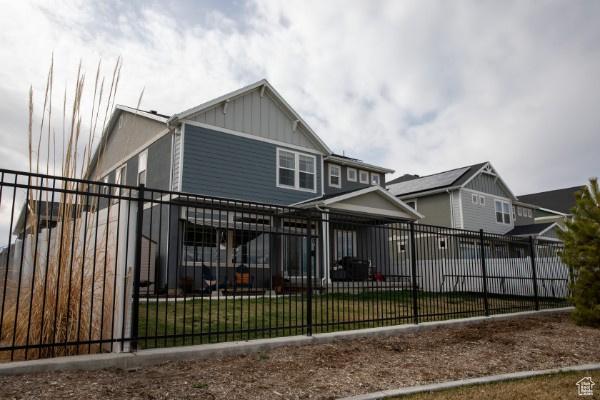 324 S Hayes Well Ln, Saratoga Springs, UT 84045 - rear view of house with a fenced front yard and board and batten siding