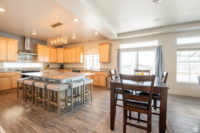 324 S Hayes Well Ln, Saratoga Springs, UT 84045 - kitchen with decorative backsplash, wood finished floors, wall chimney range hood, a center island, and light brown cabinetry