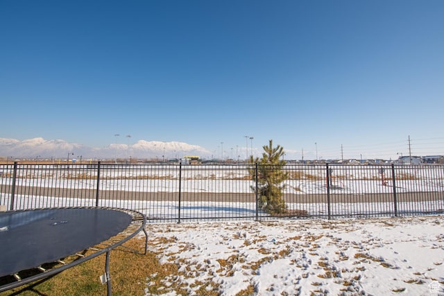 324 S Hayes Well Ln, Saratoga Springs, UT 84045 - view of yard with fence, a trampoline, and a mountain view