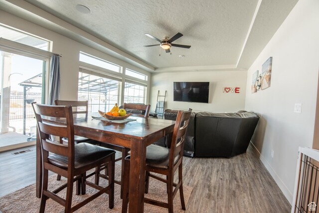 324 S Hayes Well Ln, Saratoga Springs, UT 84045 - dining area featuring a textured ceiling, visible vents, a ceiling fan, and wood finished floors