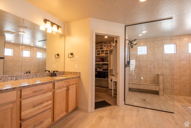 324 S Hayes Well Ln, Saratoga Springs, UT 84045 - bathroom featuring vanity, a textured ceiling, a spacious closet, and tiled shower