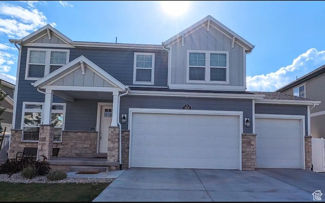 324 S Hayes Well Ln, Saratoga Springs, UT 84045 - craftsman-style house featuring an attached garage, stone siding, board and batten siding, and concrete driveway