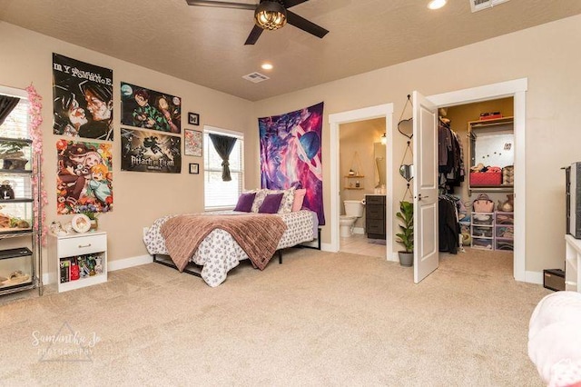 bedroom with light carpet, a spacious closet, and multiple windows