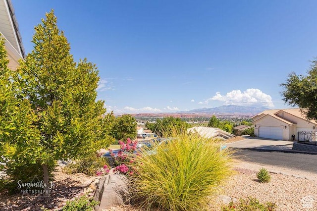 exterior space with a garage and a mountain view