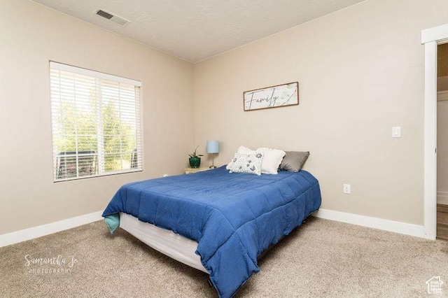 carpeted bedroom with a textured ceiling