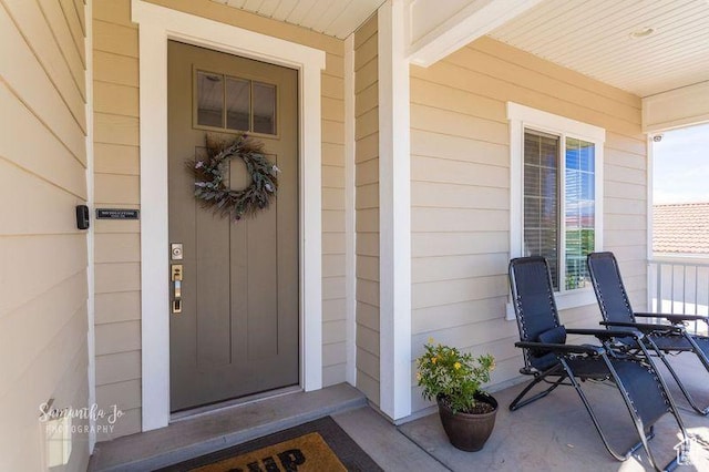 view of exterior entry with elevator and covered porch