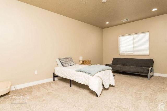carpeted bedroom featuring a textured ceiling