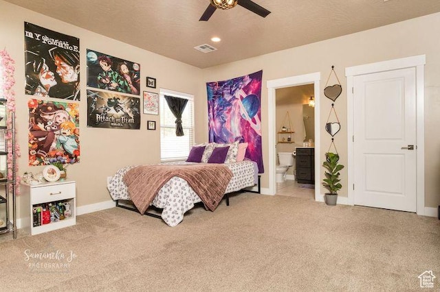 bedroom with connected bathroom, light colored carpet, and ceiling fan