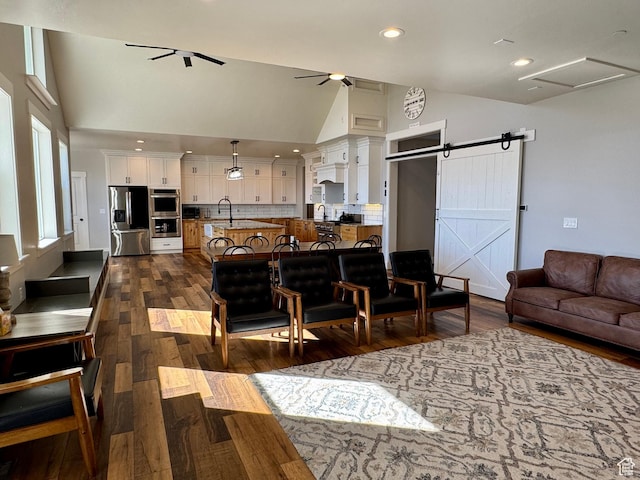6007 W 8000 S, Payson, UT 84651 - living room with a barn door, high vaulted ceiling, dark wood-type flooring, and a ceiling fan