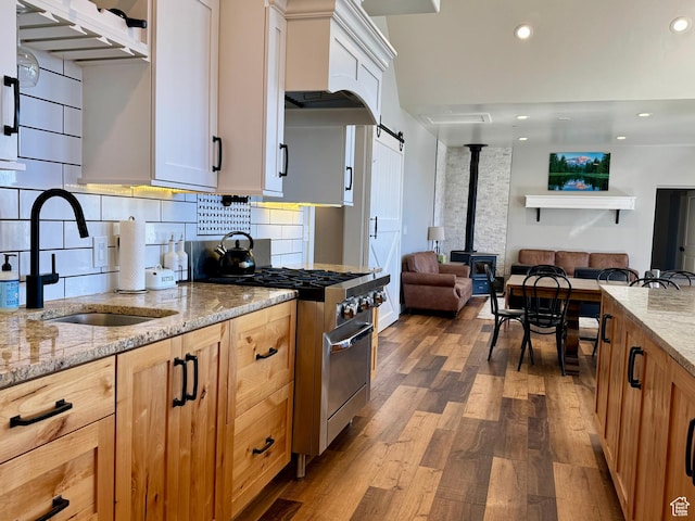 6007 W 8000 S, Payson, UT 84651 - kitchen with stainless steel range, open floor plan, light stone countertops, white cabinetry, and a sink