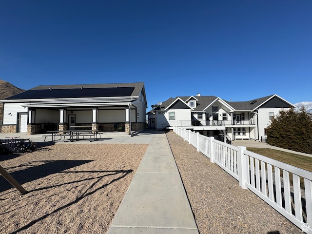 6007 W 8000 S, Payson, UT 84651 - exterior space with stone siding, a patio area, fence, and a residential view