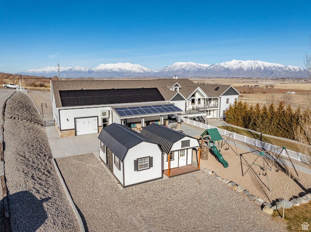 6007 W 8000 S, Payson, UT 84651 - view of front of house featuring solar panels, a playground, fence, and a mountain view