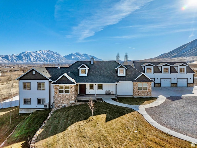 6007 W 8000 S, Payson, UT 84651 - view of front of house featuring driveway, a garage, stone siding, a mountain view, and a front yard