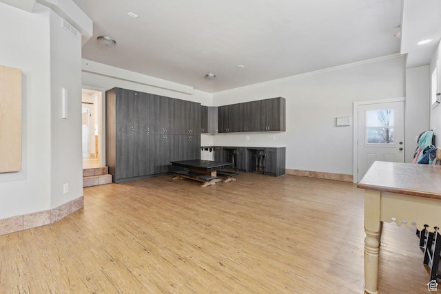 6007 W 8000 S, Payson, UT 84651 - unfurnished living room with light wood-type flooring, baseboards, and crown molding