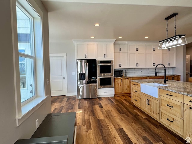 6007 W 8000 S, Payson, UT 84651 - kitchen featuring appliances with stainless steel finishes, a sink, decorative light fixtures, and white cabinetry