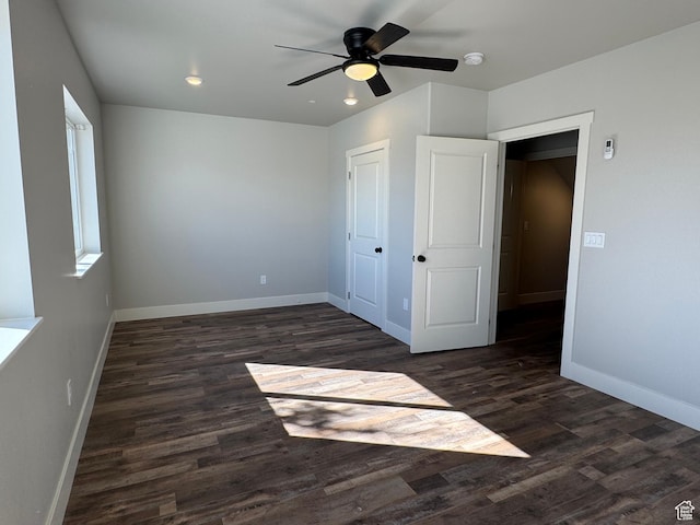 6007 W 8000 S, Payson, UT 84651 - unfurnished bedroom with dark wood-type flooring, a closet, a ceiling fan, and baseboards