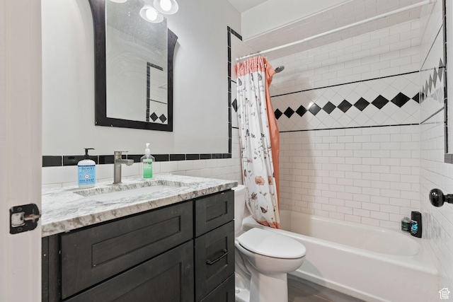 6007 W 8000 S, Payson, UT 84651 - full bathroom with toilet, a wainscoted wall, vanity, tile walls, and shower / bathtub combination with curtain