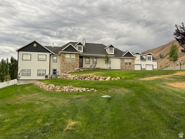 6007 W 8000 S, Payson, UT 84651 - view of front of home featuring stone siding, fence, and a front lawn