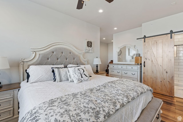 6007 W 8000 S, Payson, UT 84651 - bedroom with light wood finished floors, a barn door, a ceiling fan, and recessed lighting