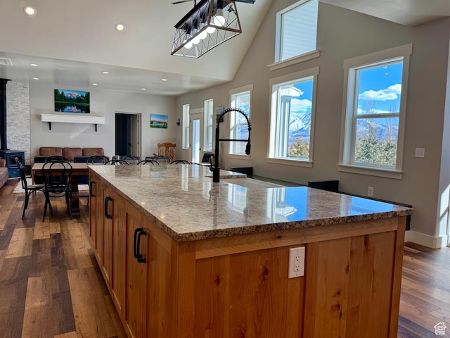 6007 W 8000 S, Payson, UT 84651 - kitchen with light stone counters, a large island, dark wood-type flooring, open floor plan, and a sink