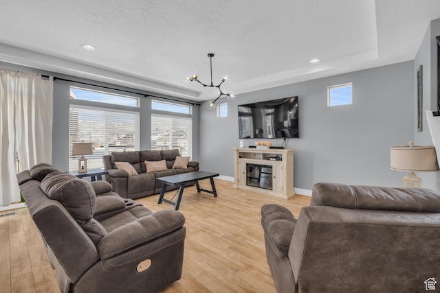 2144 S 120 E, Heber City, UT 84032 - living room with a raised ceiling, a chandelier, light wood finished floors, healthy amount of natural light, and a textured ceiling