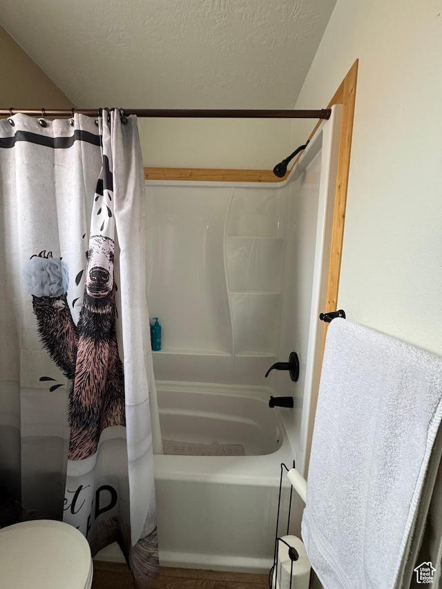 1150 W Red Hills Pkwy Unit 123, Washington, UT 84780 - bathroom featuring shower / bath combo, toilet, and a textured ceiling